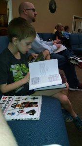here we all are. Caleb is stuck between Jack and myself, but each of us have our Bibles open, listening to our guest preacher.